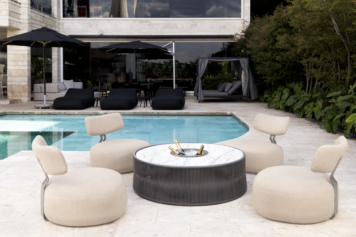 Magna Oasis audio table in a poolside seating area; optional ice-bucket configuration shown