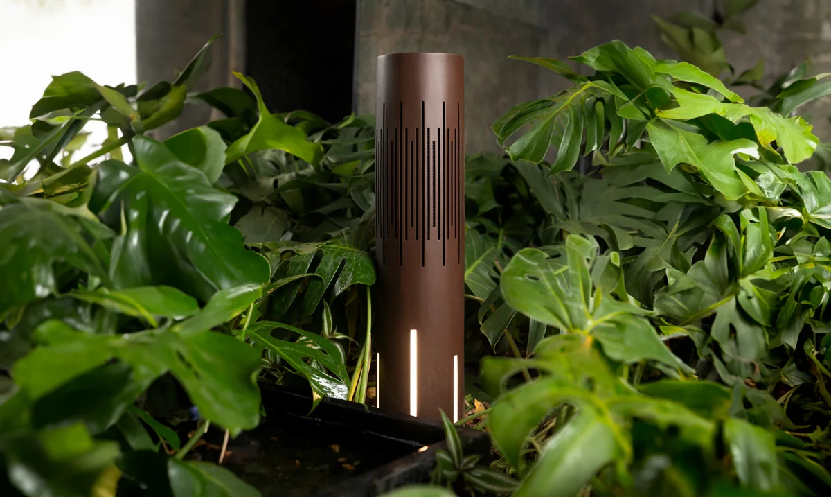 Magna Polly landscape tower with integrated lighting among garden foliage